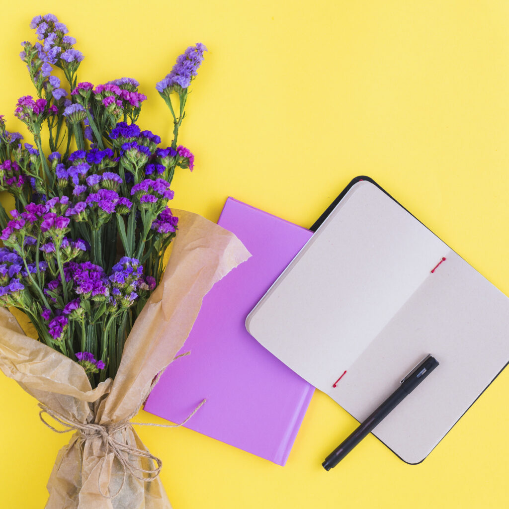 Our Services flower bouquet diaries pen yellow backdrop